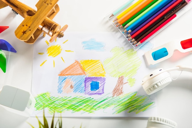 Child colorful drawing landscape my home dream on white paper