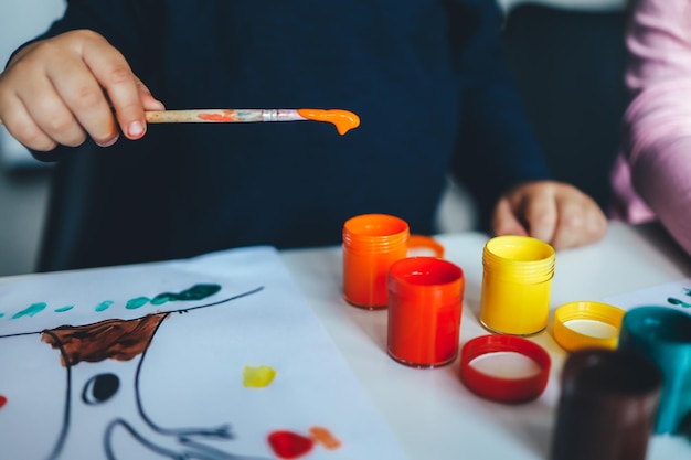 Child draw paint on a brush Children development concept