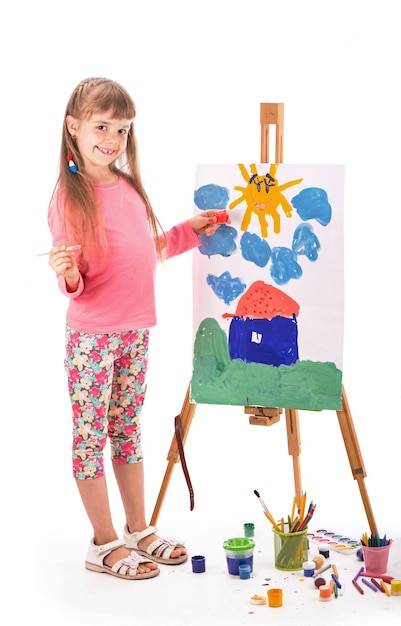 The child draws a house Children's painting Little girl draws the sun The schoolboy does his homework in art Arts and crafts for children Paint on children's hands Isolated on white background