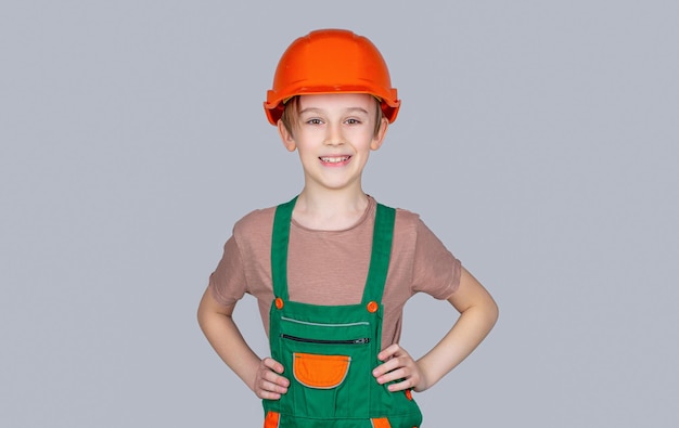 Child dressed as a workman builder Little boy wearing helmet Portrait little builder in hardhats Child building helmet hard hat Little builder in helmet