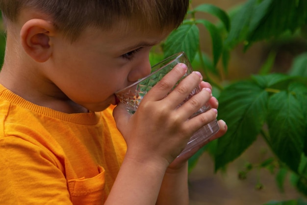 The child drinks water from a glass Selective focus