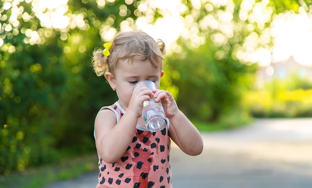 The child drinks water from a glass Selective focus