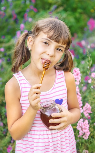 Child eats honey summer photo