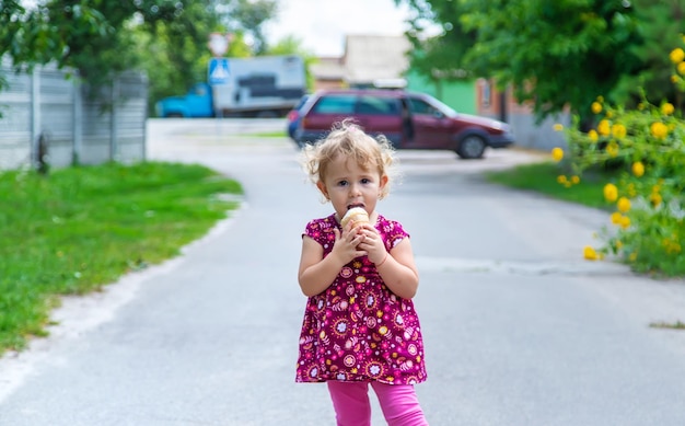 The child eats ice cream on the street Selective focus