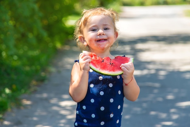 A child eats watermelon in the park Selective focus