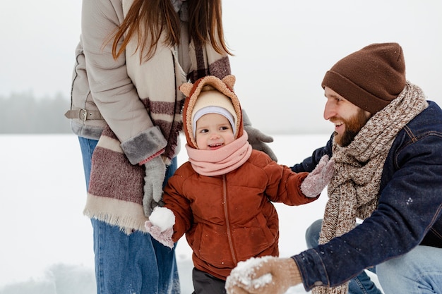 Child enjoying winter activities with their family