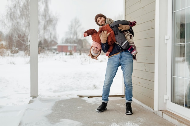 Child enjoying winter activities with their family