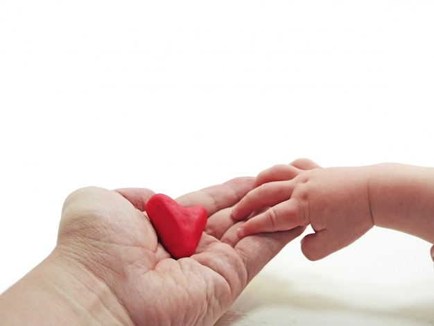 Child and father hand with heart made from Play Clay