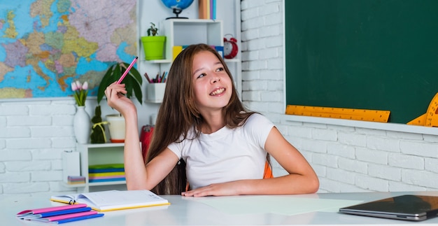 Child from elementary school in classroom, Education.