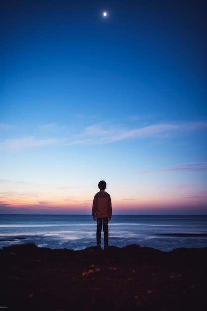 A child gazing at the horizon isolated on a dusk gradient background