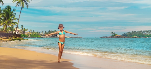 Child girl on the beach in Sri Lanka