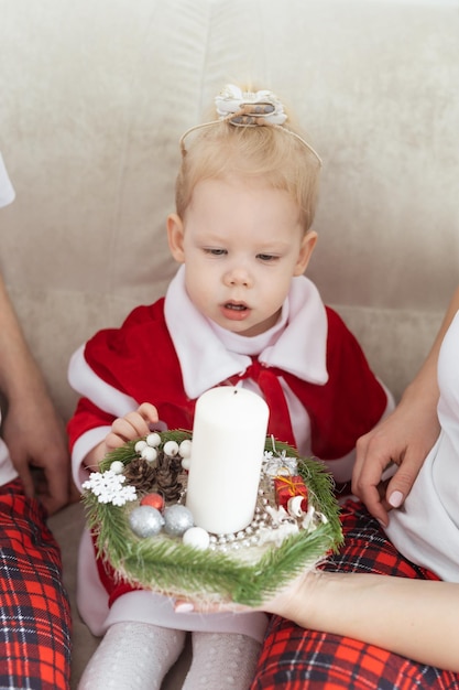 Child girl dressed in christmas dress with cochlear implants having fun at home diversity and heari