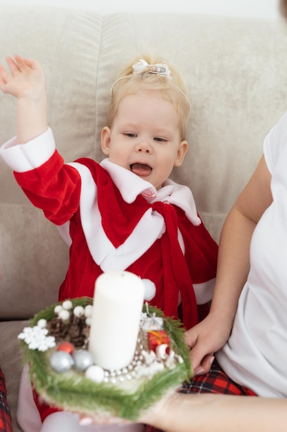 Child girl dressed in christmas dress with cochlear implants having fun at home diversity and hearing aid and innovating technologies for treatment of deafness Copy space and place for advertising