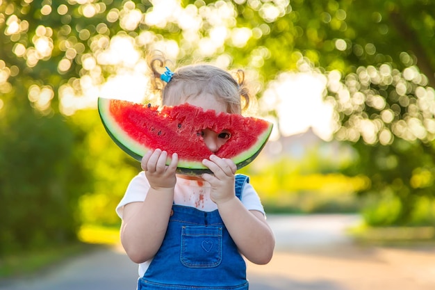 Child girl eats watermelon in summer Selective focus