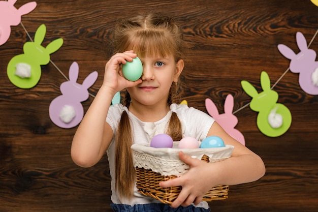 Child girl holding basket with easter