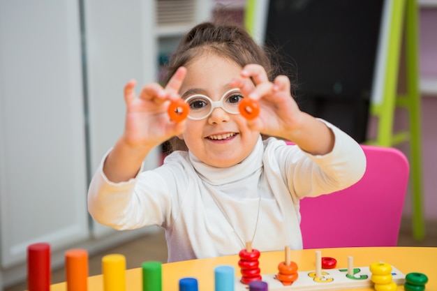 child girl  plays in educational classes