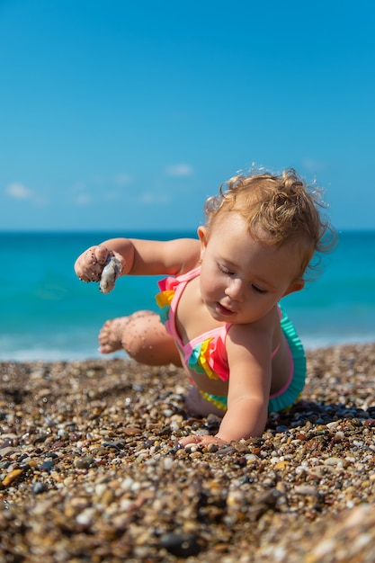 Child girl at the sea. Selective focus. Baby.