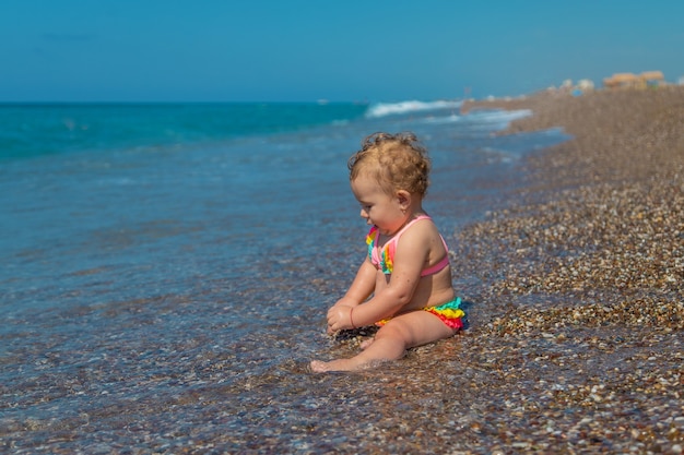 Child girl at the sea. Selective focus. Baby.