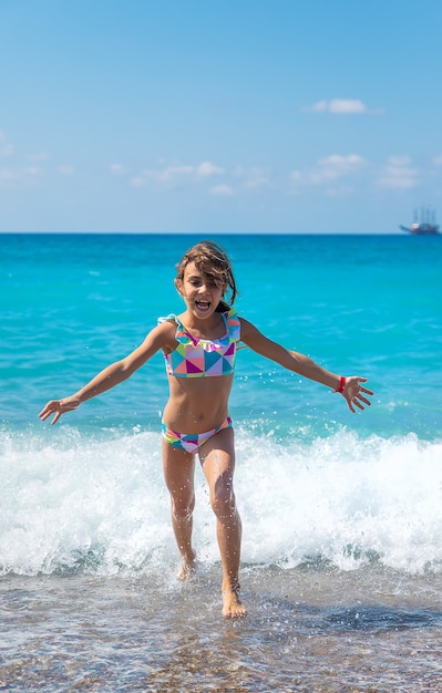 Child girl at the sea. Selective focus.