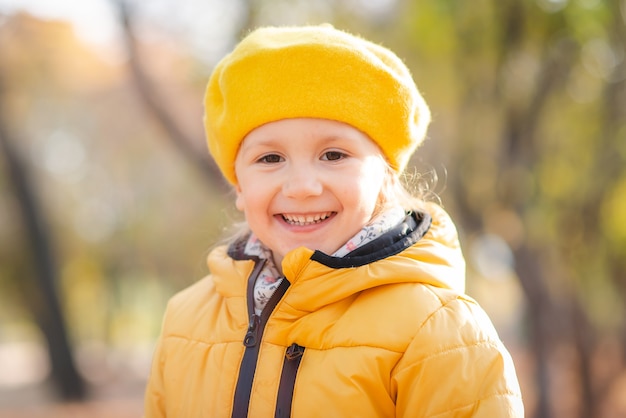 A child girl walks in the autumn park