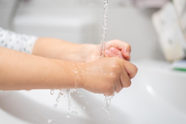 Child girl washing hands Young woman washing hands in the modern bathroom People hygiene