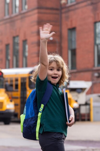 Child go to school schoolboy getting on school bus american school happy children ready to study