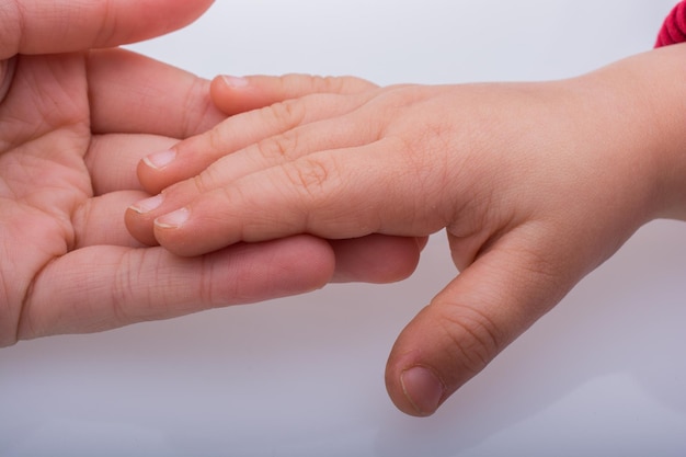 Child and grown up hands together