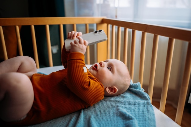 Child having fun playing with mobile device Toddler watching a video on smartphone