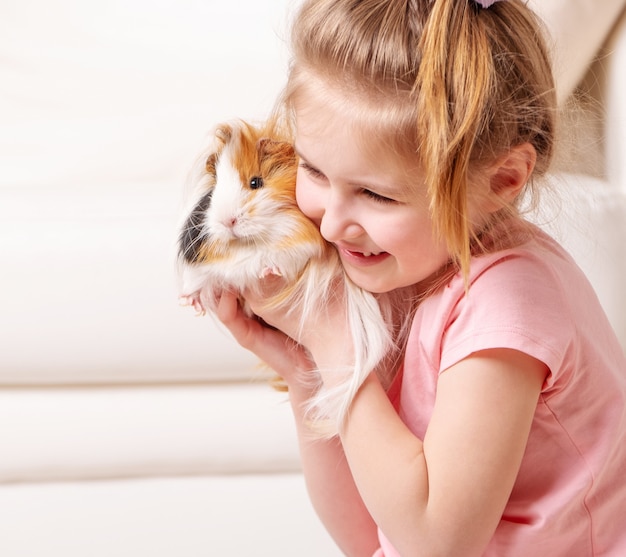 Child having fun with guinea pig