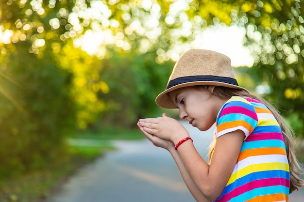 The child hides the find in his hands Selective focus