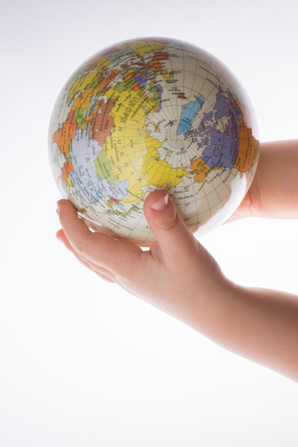 Child holding a globe in his hand