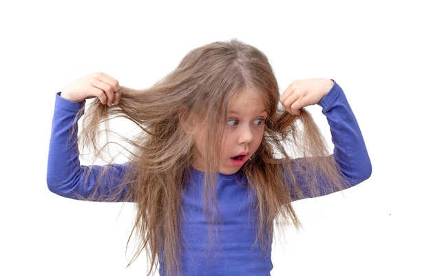 Child holding hair being in shock about hair loss