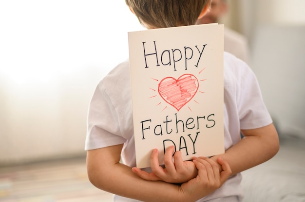 Child holding surprise greeting card