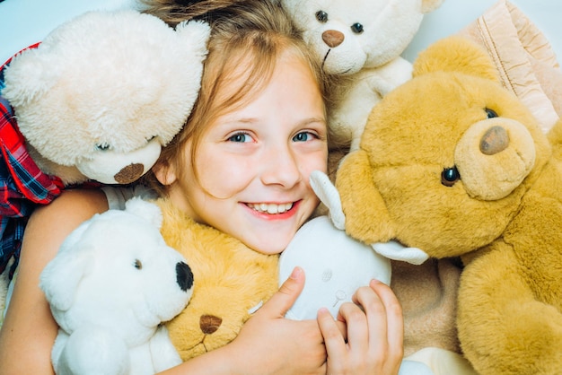 Child hugging teddy bear kid funny face near toys toys dream kid girl dreams near tiys teddy childho