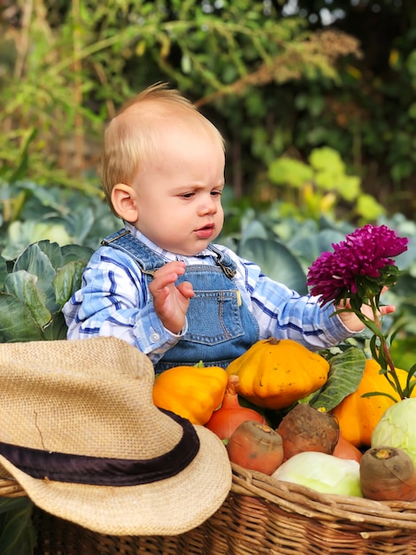 The child is a little farmer. Farm assistant.