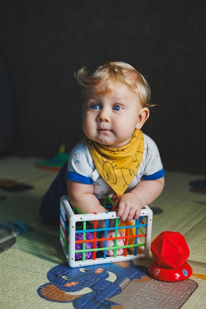 The child is lying on the mat playing with soft balls Educational toys for the motor skills of the babys hands Child development Sensory experience