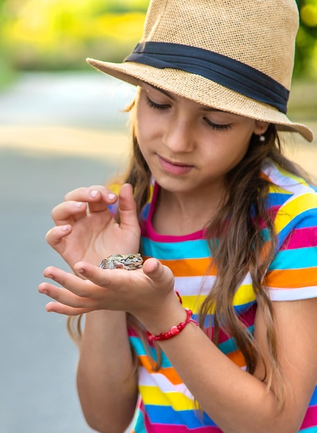 The child is playing with the frog Selective focus