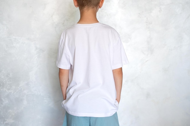 The child is wearing a white Tshirt Place for advertising