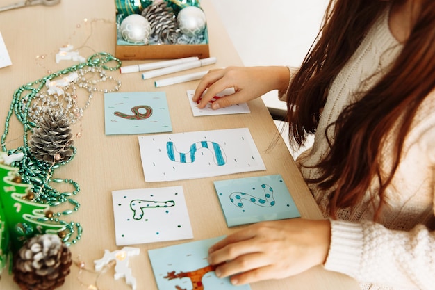 a child makes a Christmas advent calendar out of paper with his own hands diy close up