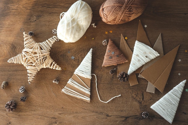 Photo child makes christmas decoration from yarn