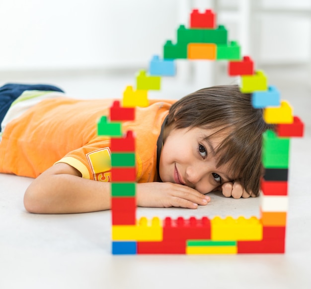 Child making a new dream home with blocks