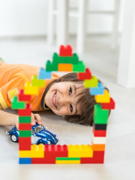 Child making a new dream home with blocks