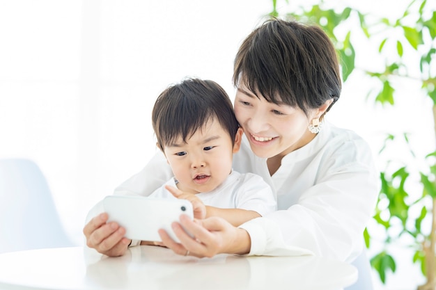 Child and mom crazy about smartphone screen