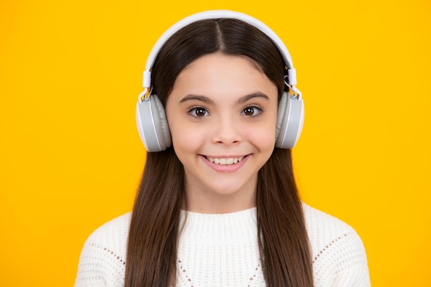 Child music concept Teenager child girl dances in rhythm of melody listens song in headphones Child listening to music through earphones