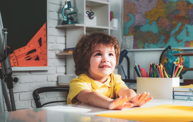 Child near chalkboard in school classroom educational process kids gets ready for school