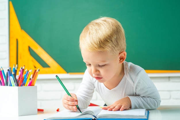 Child near chalkboard in school classroom First school day Individual tutoring Education