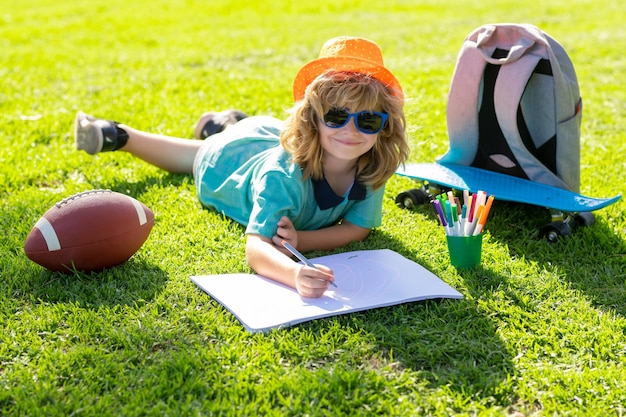 Child painter draw on playground child artist paints creativity vacation kid boy draws in park layin