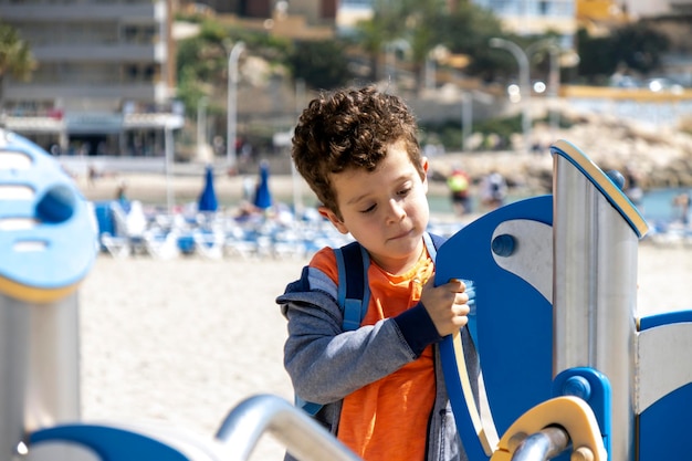 Child playing in playground facilities located at the beach