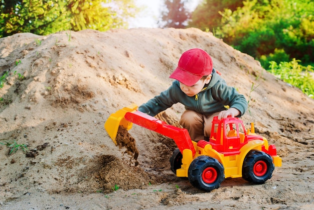 Child playing in the sand excavator