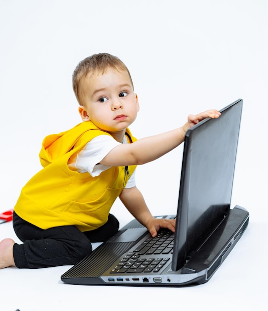 Child playing with laptop Small boy looking in computer